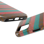 Striped Tribal Tough Phone Case — Retro Teal & Coral Protective Cover displayed on a wood desk beside a laptop and earbuds as a fractyl shockproof iphone 17 pro case