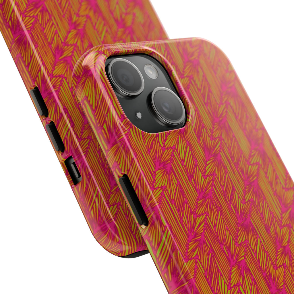Tough Phone Case — Vibrant Tropical Herringbone Pattern, impact resistant iphone 17 case shown on a desk beside a laptop and notebook