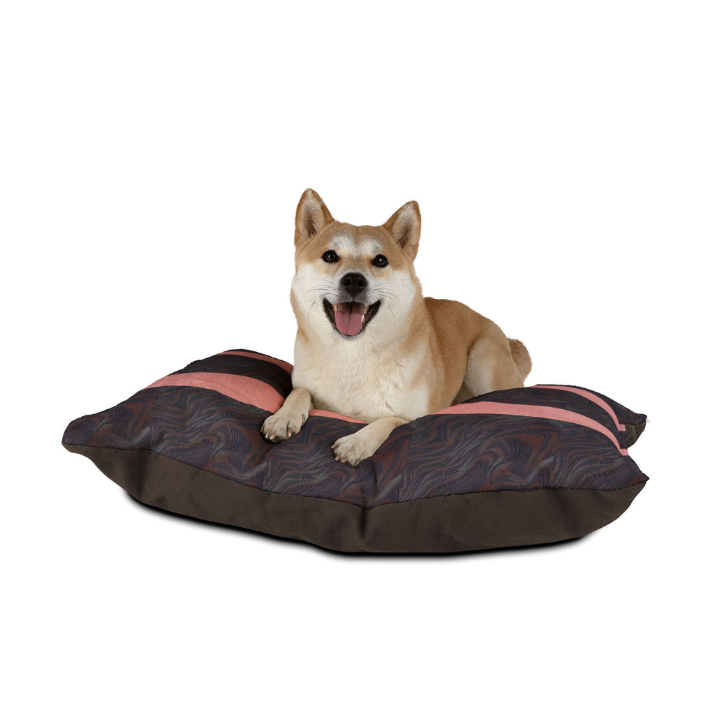 A happy dog enjoying the Marbled Charcoal Pet Bed with Pink Stripes, demonstrating its comfort and appealing design. This machine washable pet bed suits dogs of all sizes, providing a plush, cozy retreat, ideal for indoor lounging and enhancing any modern pet space.