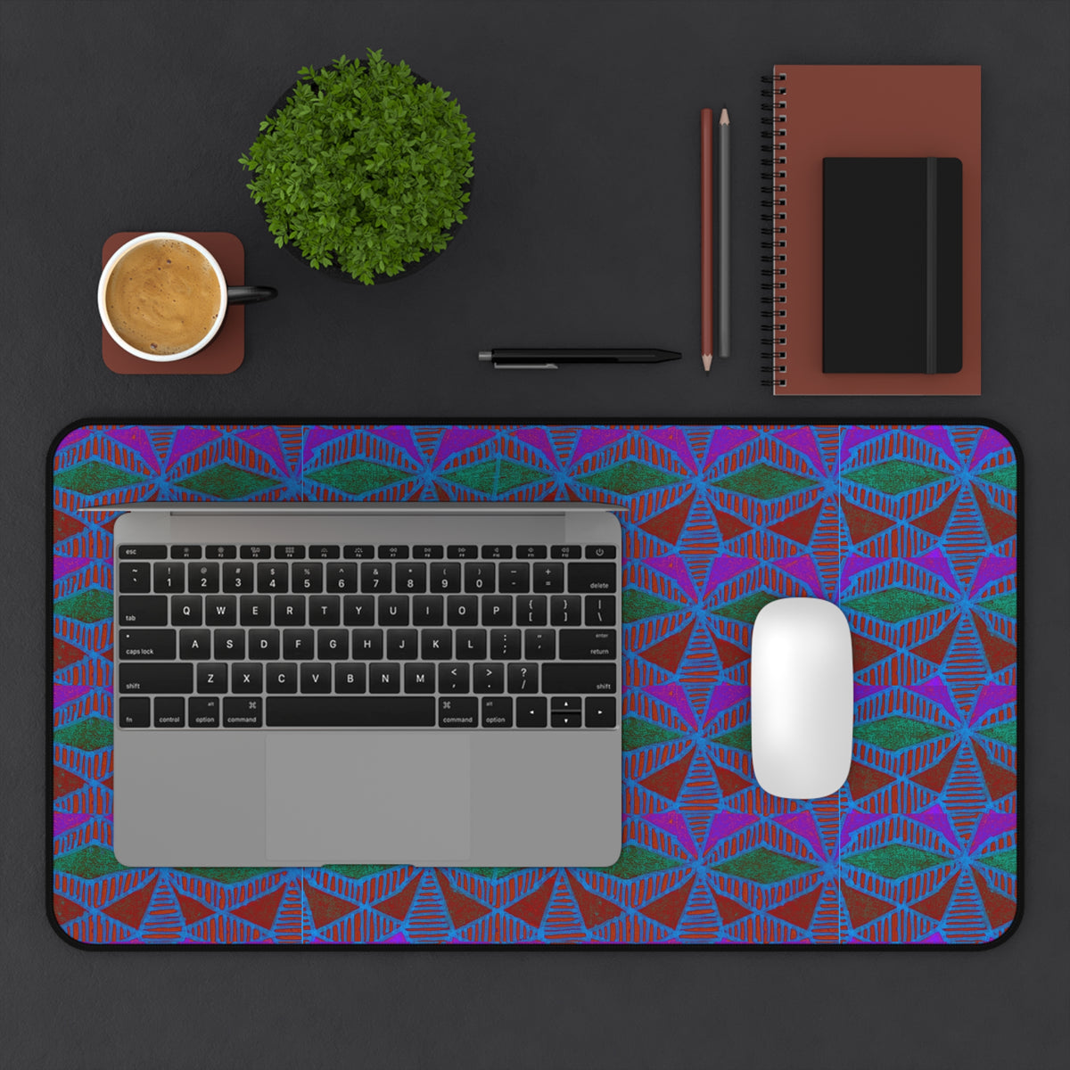 Geometric Neon Wave Desk Mat — Retro Purple & Teal Gamer Desk Pad gaming desk mat arranged with a laptop, mouse, coffee, plant, and stationery.