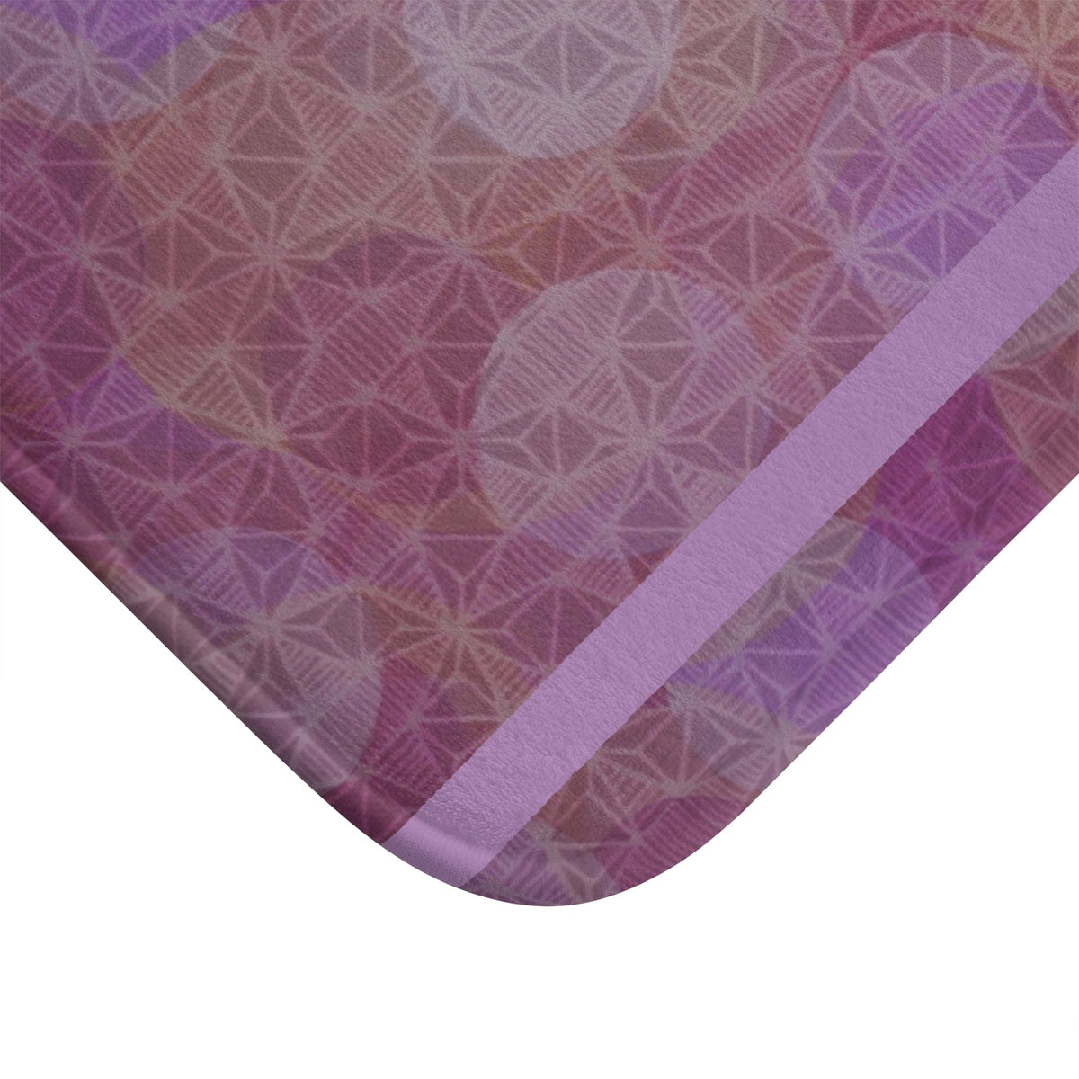 Close-up view of the edges of the Pastel Geometric Bath Mat — Lavender Pink Bokeh Floor Rug, showcasing the rounded corners and reinforced binding for durable use. This anti-slip floor mat adds a soft bathroom mat experience, embodying a boho aesthetic with its floral and geometric patterns, making it ideal for a luxurious touch in your girly bathroom or as a pink bath mat gift.