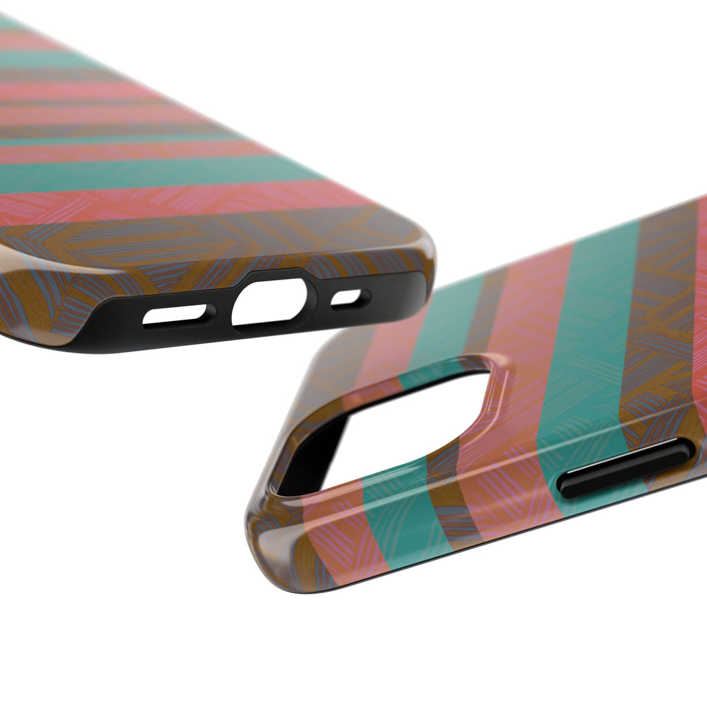 Striped Tribal Tough Phone Case — Retro Teal & Coral Protective Cover photographed on a desk beside earbuds as a colorful fractyl shockproof iphone 17 pro case