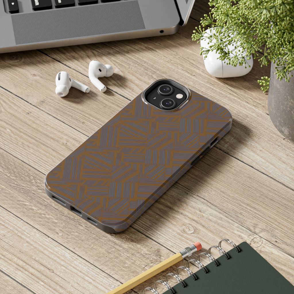 Tough Phone Case — Geometric Maze Brown Protective Cover, wireless charging iphone 18 pro max case shown on a wooden desk in a modern workspace.