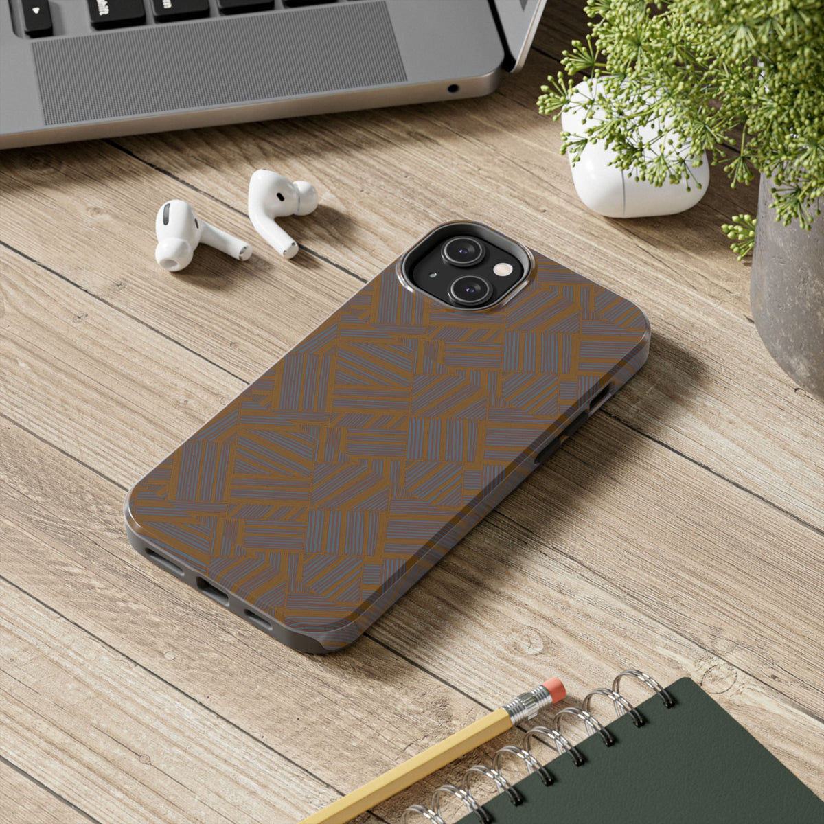 Tough Phone Case — Geometric Maze Brown Protective Cover, wireless charging iphone 18 pro max case shown on a wooden desk in a modern workspace.