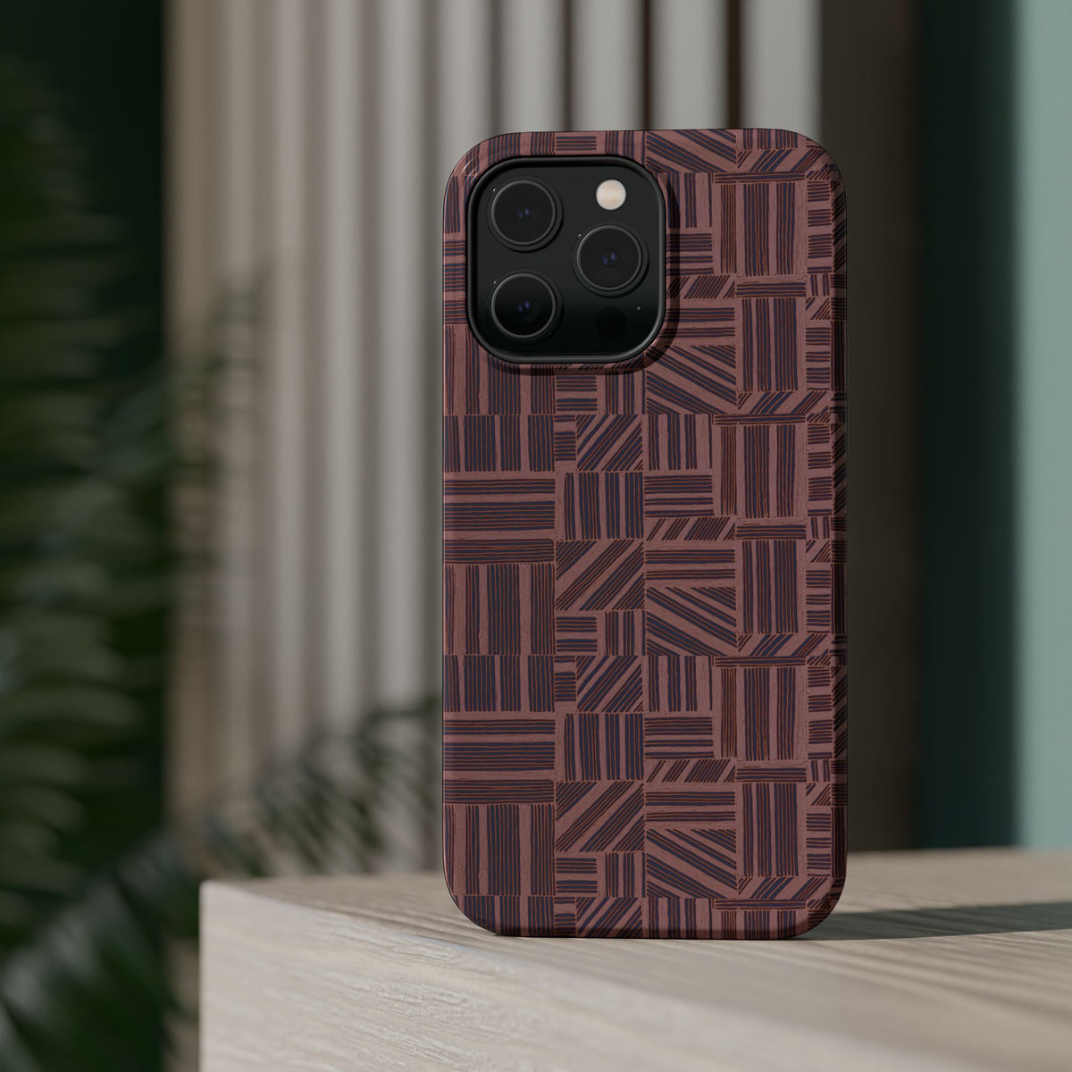 MagSafe Impact Resistant Phone Case - Geometric Brown Pattern, Dual-Layer Protection, angled case against an abstract background; impact resistant iphone 17 pro max case
