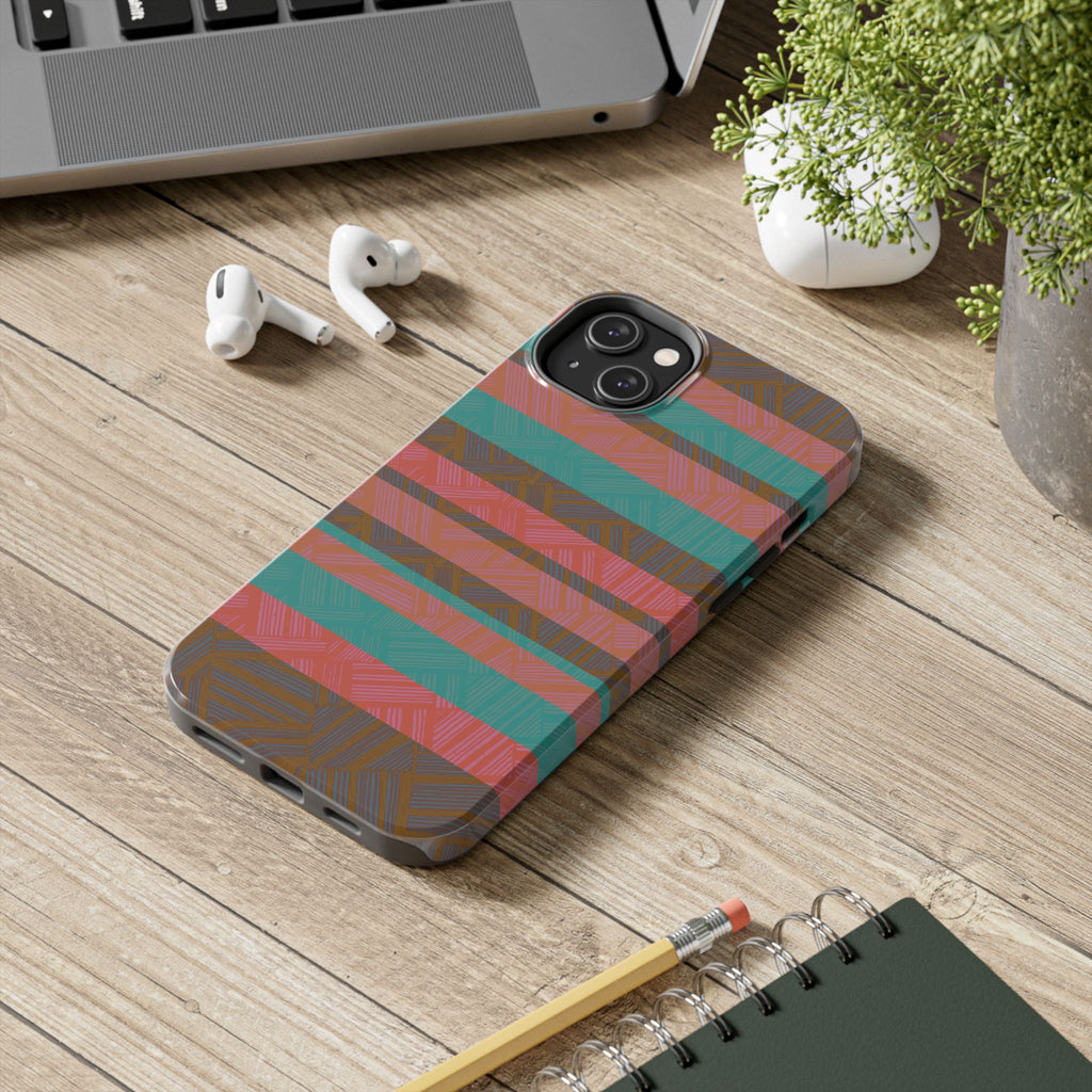 Striped Tribal Tough Phone Case — Retro Teal & Coral Protective Cover shown in lifestyle use on a wooden desk as a fractyl shockproof iphone 17 pro case