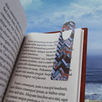 Horse Pattern Metal Bookmark – Geometric Fox & Pony Design, colorful foxy page marker holding a place in an open book by the ocean