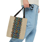Boho Geometric Everyday Patterned Canvas Tote Bag With Reinforced Handles, 3 Sizes, carried by hand beside casual blue jeans, highlighting its blue and tan print and black shoulder handles. Patterned canvas tote for art tote, beige bag, bohemian bag, boho tote, canvas tote, eco shopping, everyday tote, gift for her, market bag, neutral tote, printed tote, summer tote, and tribal tote use.