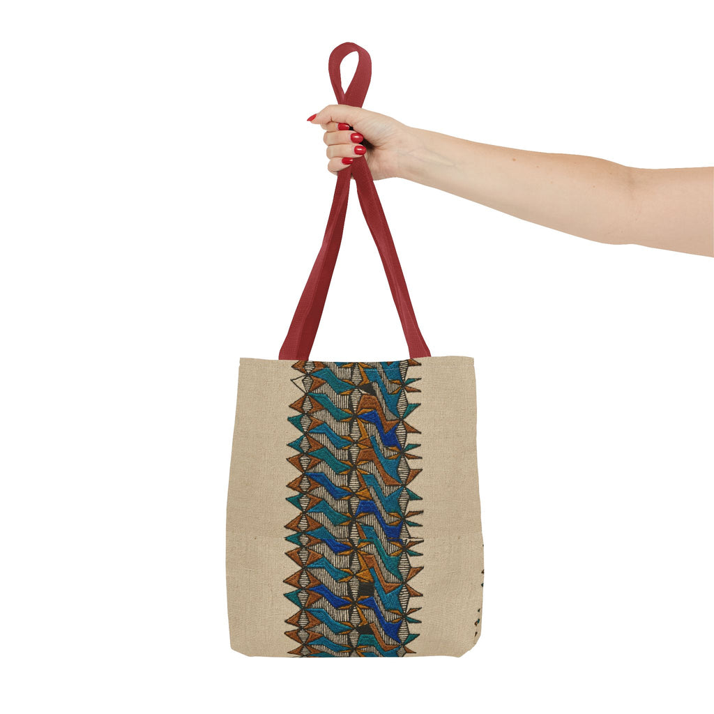 Boho Geometric Everyday Patterned Canvas Tote Bag With Reinforced Handles, 3 Sizes, held by hand with red handles and a blue and tan geometric print. Patterned canvas tote with art tote, beige bag, bohemian bag, boho tote, canvas tote, eco shopping, everyday tote, gift for her, market bag, neutral tote, printed tote, summer tote, and tribal tote details.