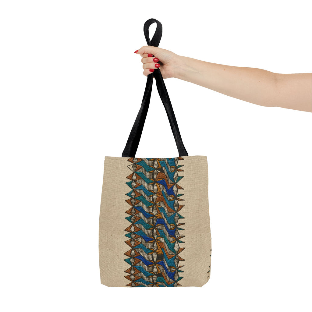 Boho Geometric Everyday Patterned Canvas Tote Bag With Reinforced Handles, 3 Sizes, held by hand to show the beige tote body, blue and tan tribal-style print, and black handles. Patterned canvas tote with art tote, beige bag, bohemian bag, boho tote, canvas tote, eco shopping, everyday tote, gift for her, market bag, neutral tote, printed tote, summer tote, and tribal tote character.