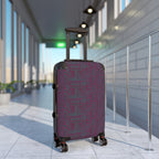 Geometric Plum Carry-On Suitcase – Stylish Patterned Rolling Luggage, stylish expandable carry on suitcase standing in an airport with a plum and teal geometric printed front and 360-degree wheels.
