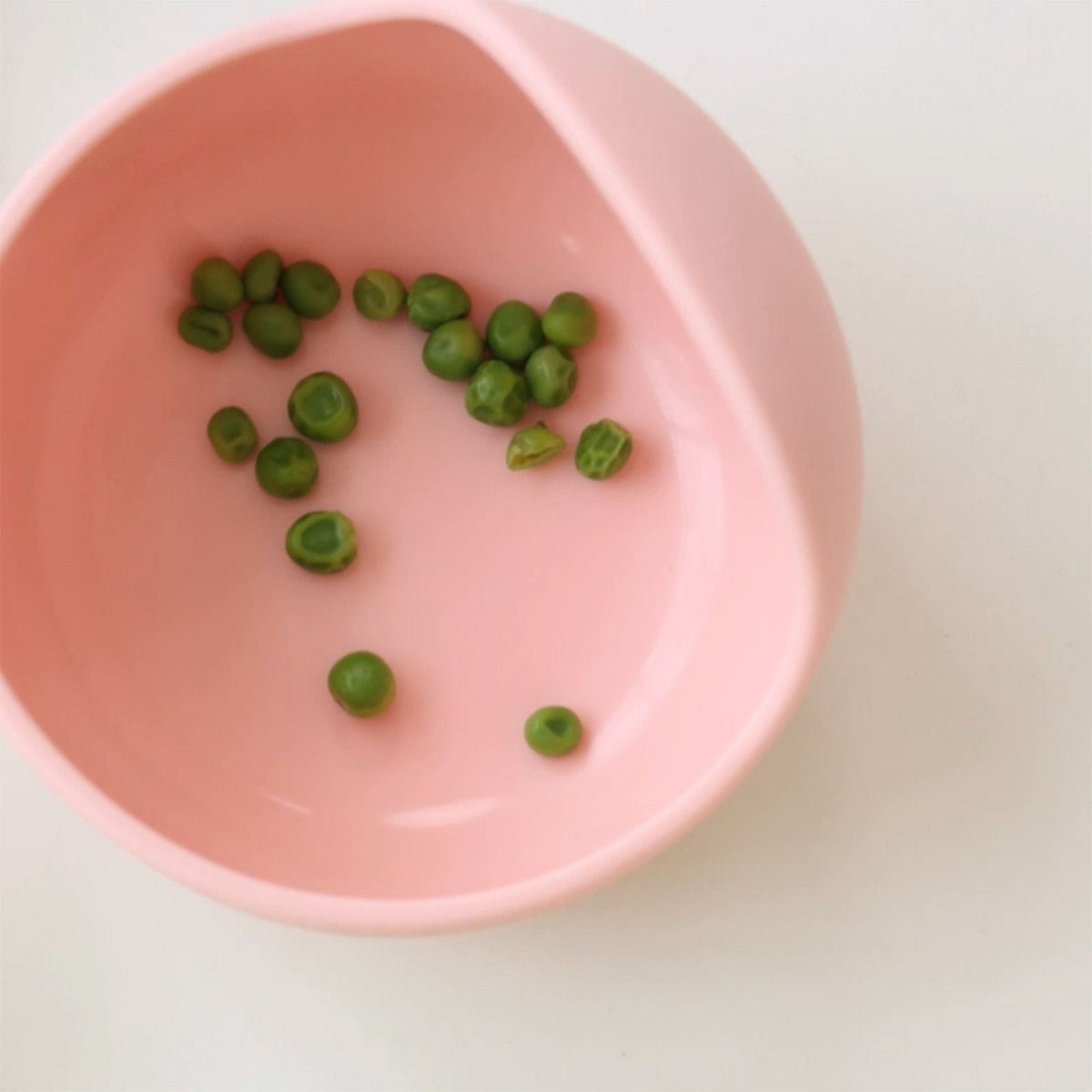 Pink silicone bowl with peas from the Bite Size Bundle Baby's Brew toddler feeding set