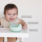 Baby using the suction bowl from the Bite Size Bundle Baby's Brew toddler feeding set during mealtime