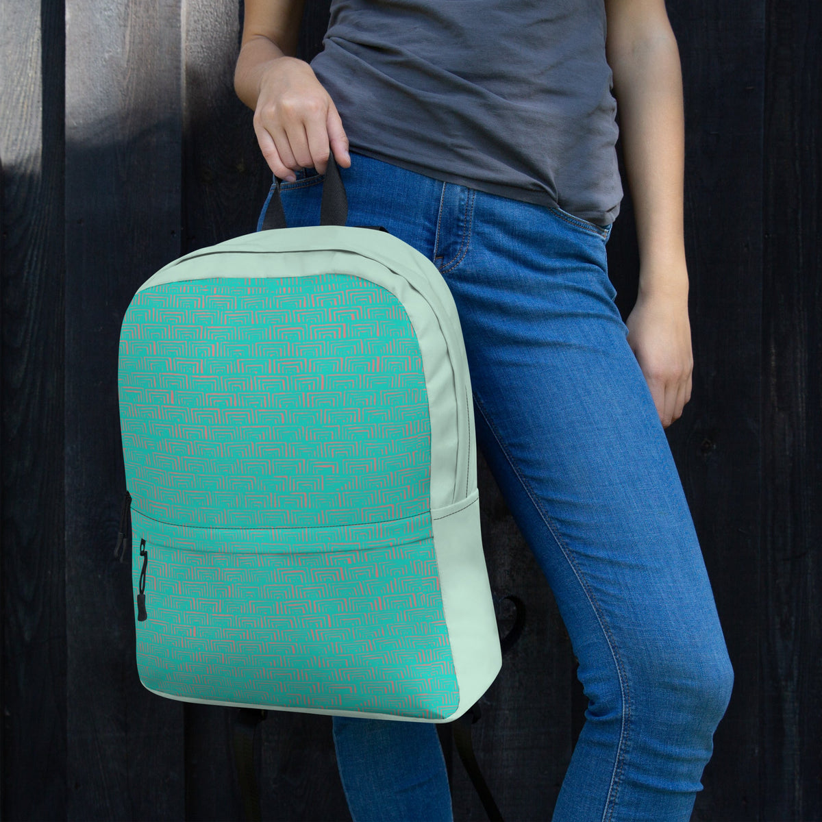Young woman holding a medium size backpack, great for back to school. This backpack boasts a modern design and is suitable for carrying essential items with ease.