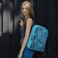 Stylish medium size backpack perfect for back to school 2026, featuring a vibrant blue and black swirl design, carried by a woman on her shoulder.