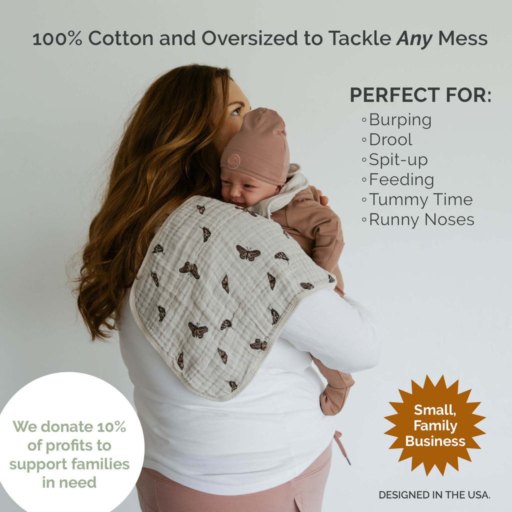 Butterfly Set - Muslin Burp Cloths (4 Pack) absorbent burp cloths for under 2, shown protecting a mother's shoulder while burping a baby.