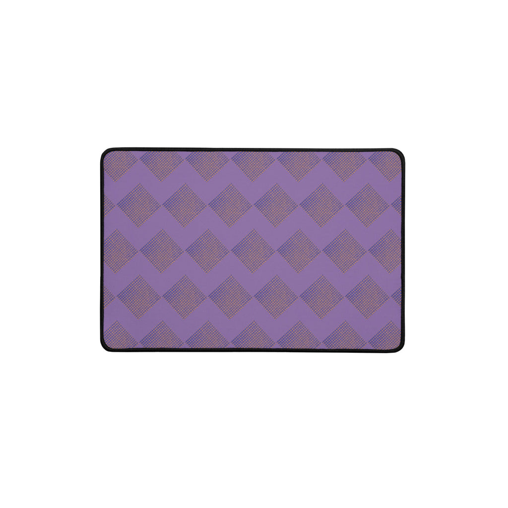 Showcasing a large desk mat in purple with intricate diamond patterns, ideal for both gaming and work environments.