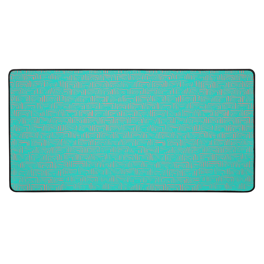 Vibrant desk mat for gaming featuring a unique turquoise geometric pattern with hemmed edges, designed for smooth and steady use.